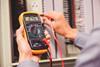 A photo of an engineer using a voltmeter