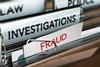 A photograph of folders labelled 'Investigations' and 'Fraud'