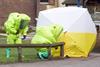Investigators wearing hazmat suits whilst securing a tent for investigations into the Novichok poisonings