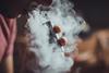 A picture showing an electronic cigarette being used