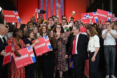 Keir Starmer celebrates with a crowd who are carrying placards that say CHANGE.