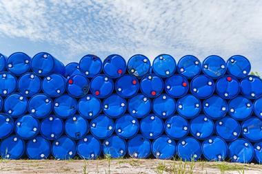 Plastic blue chemical barrels stacked up