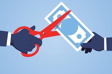An illustration showing a hand holding scissors and cutting a bank note