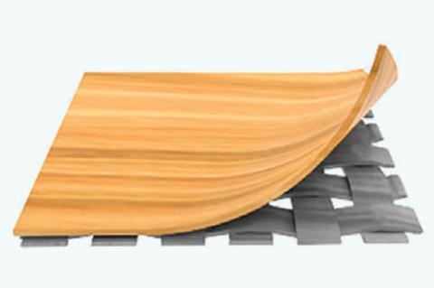 A layer of a wooden material is peeled back to reveal a woven material underneath