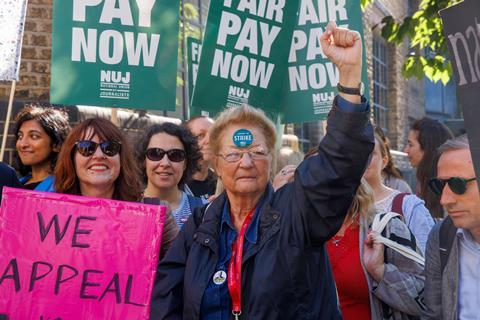 People protesting for fair pay on a picket line